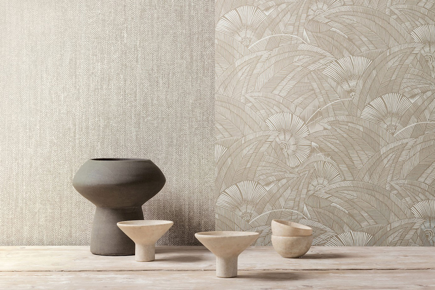 Showcase of 2 luxury wallpapers on a wall in the background and some ceramic pots on a table in the foreground