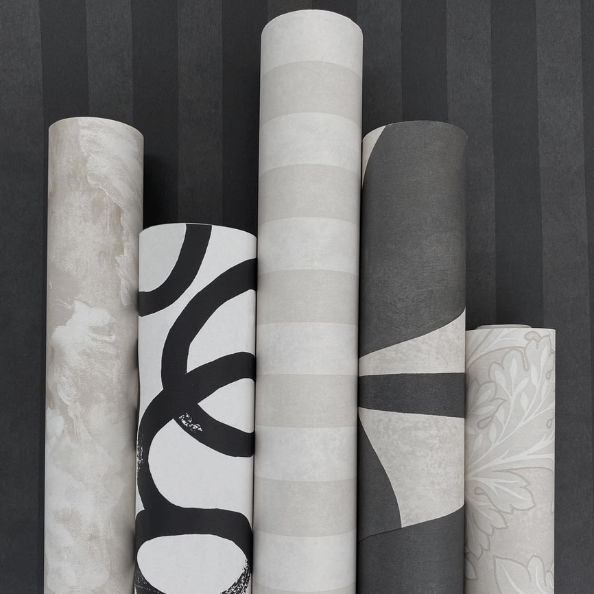 Photo showing 5 rolls of wallpaper in greys and black with various patterns. It shows how wallpaper is rolled to accompany the article: How much Wallpaper do I need?