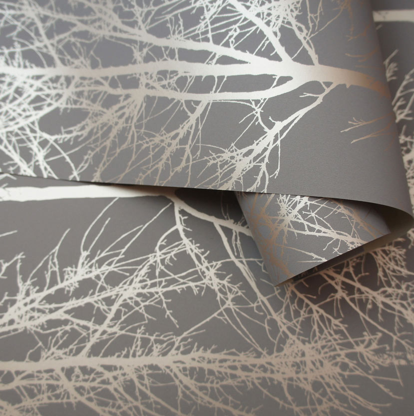 Loosely rolled roll of Metallic Tree Silhouette design wallpaper
