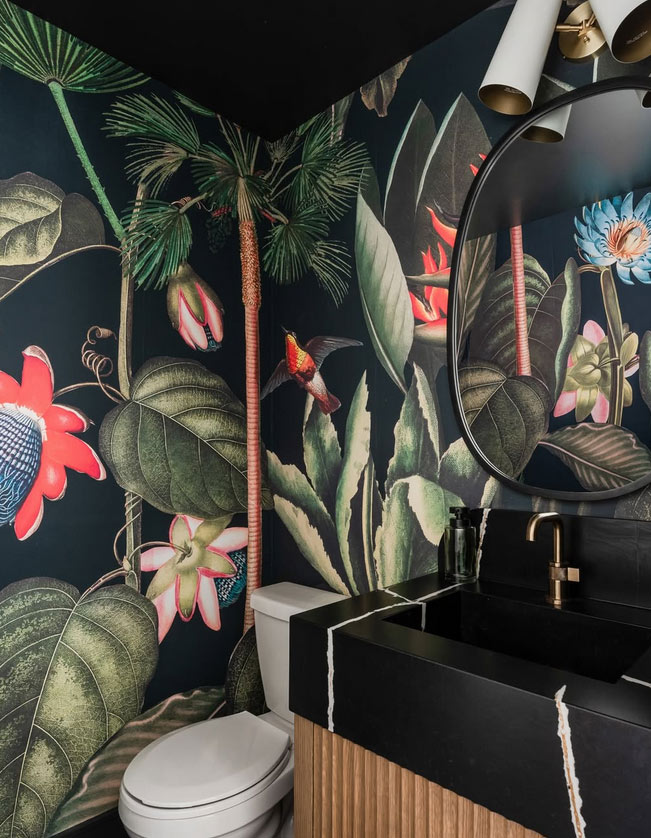Powder Room (toilet, basin and mirror) with a black tropical wallpaper installed on the walls