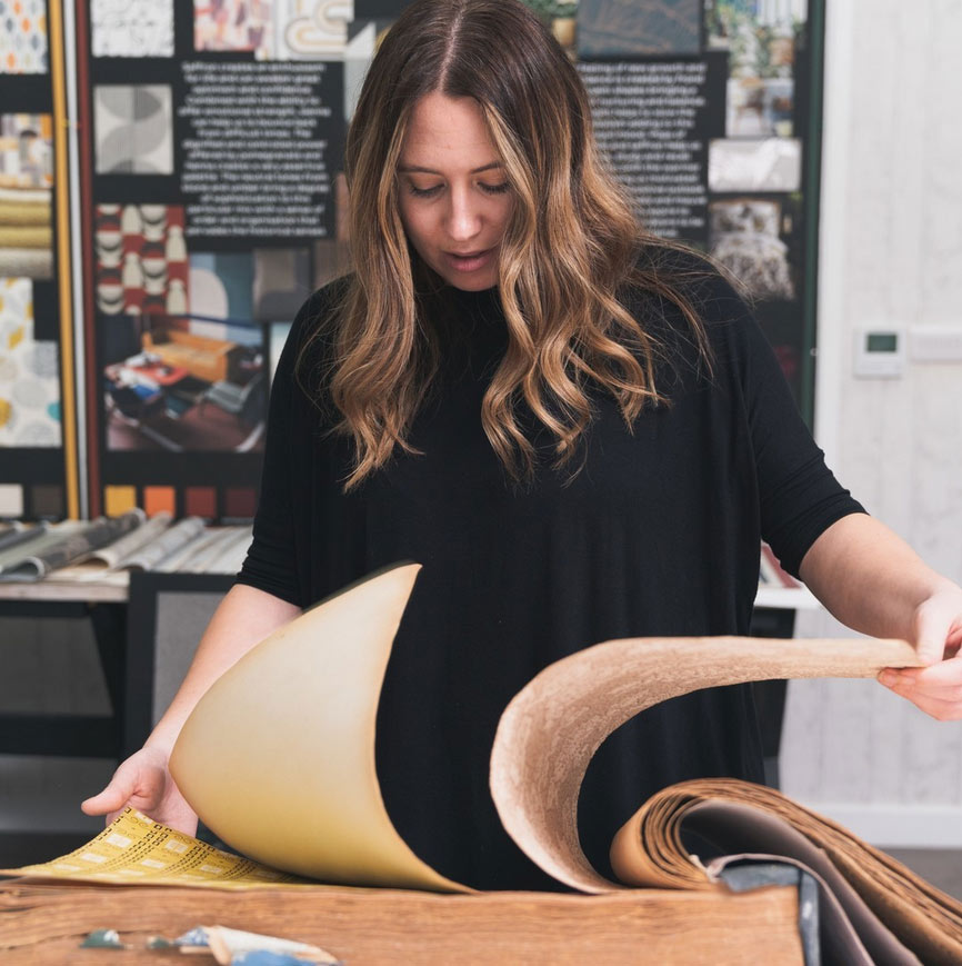 Paging through a wallpaper sample book with La Muur Fine European wallpaper
