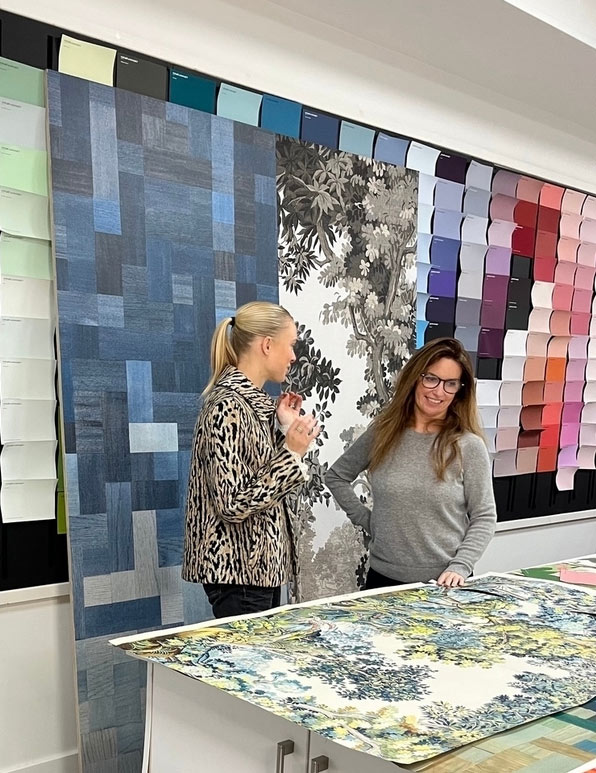 Wallpaper Design Process and discussions with 2 designers in the foreground and colour swatches in the background