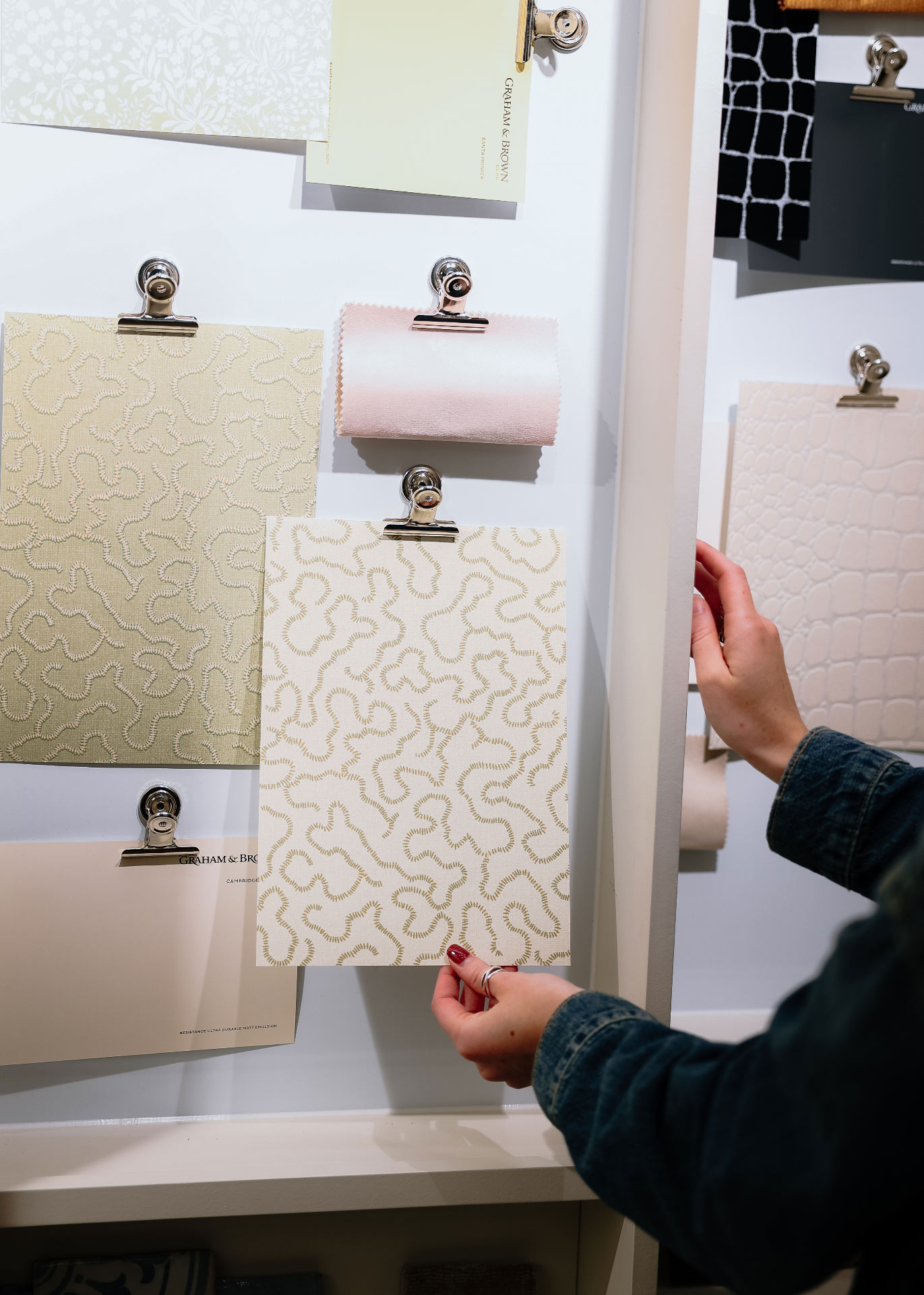 Holding a wallpaper sample from an interiors mood board