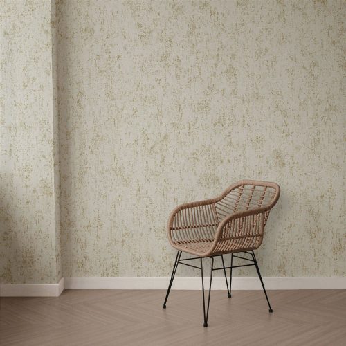 Room shot of the Mineral Plaster Wallpaper Metallic Gold Cream installed on a wall, with a chair in the foreground