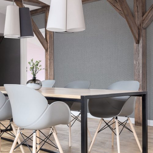 Boardroom with Woven Hessian Wallpaper Grey installed on the walls. Also shown are rustic wooden rafters, pendant lamps over a boardroom table and Scandanvian style chairs