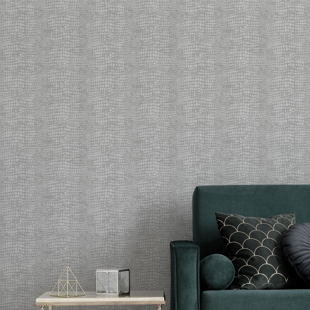 Lounge wall showcasing the grey crocodile leather look wallpaper on the wall and an emerald couch and table in the foreground