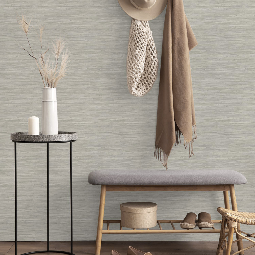 Entrance hall with Deeply Textured Grasscloth Wallpaper Beige installed on the wasll. Also shows small bench, coat hooks with coat and hat plus small table and vase