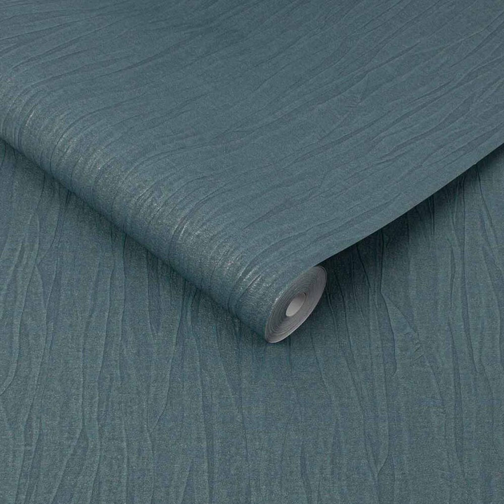 Roll of emerald green textured silk wallpaper with metallic bronze, slightly unrolled
