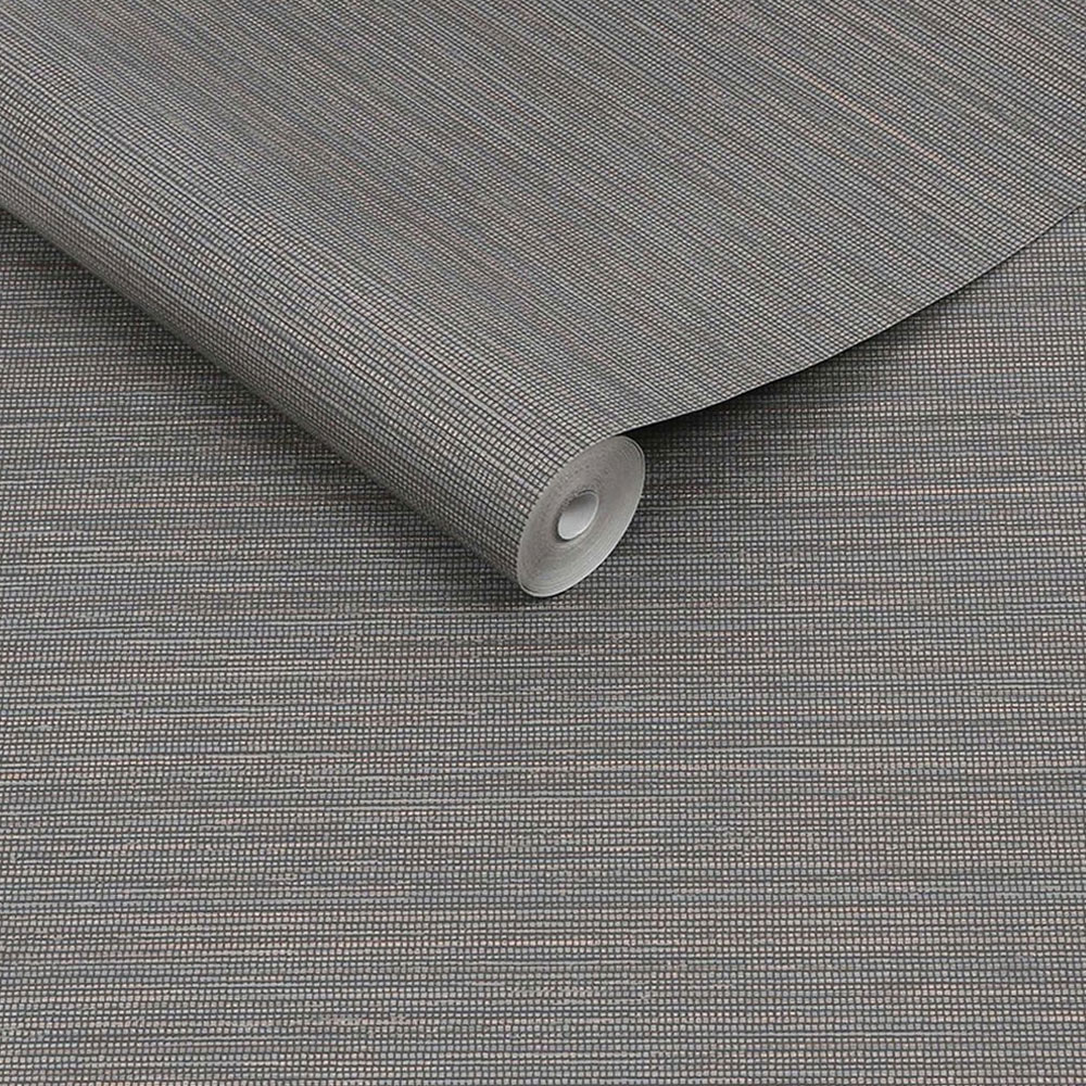 Roll of smoky quartz dark grey charcoal wallpaper with textured grasscloth and gold metallic detailing. It is slightly unrolled