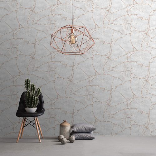 Styled room with the Kintsugi Wallpaper Rose Gold installed on the wall. Also features rose gold geometric metal pendant light, cactus on black cafe chair with pillows and ceramic on the floor