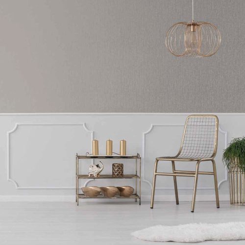 Styled room with the Metallic Draped Silk Wallpaper Quartz installed on half of the wall. Also features gold metal chair, copper pendant light, dispaly table with candles and accessories plus plant on stand
