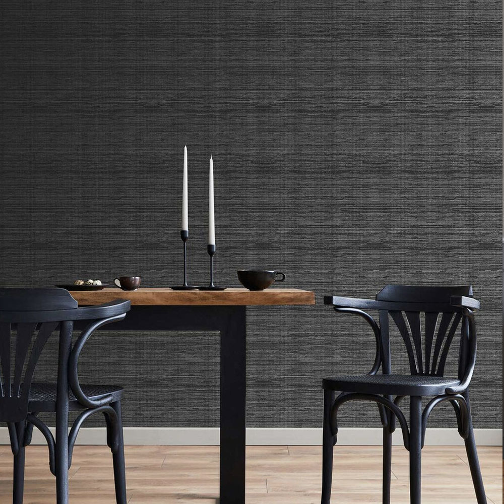 Dining room with Superfresco Easy Gilded Texture Wallpaper installed on the wall, also features a table with candle holders and 2 black chairs