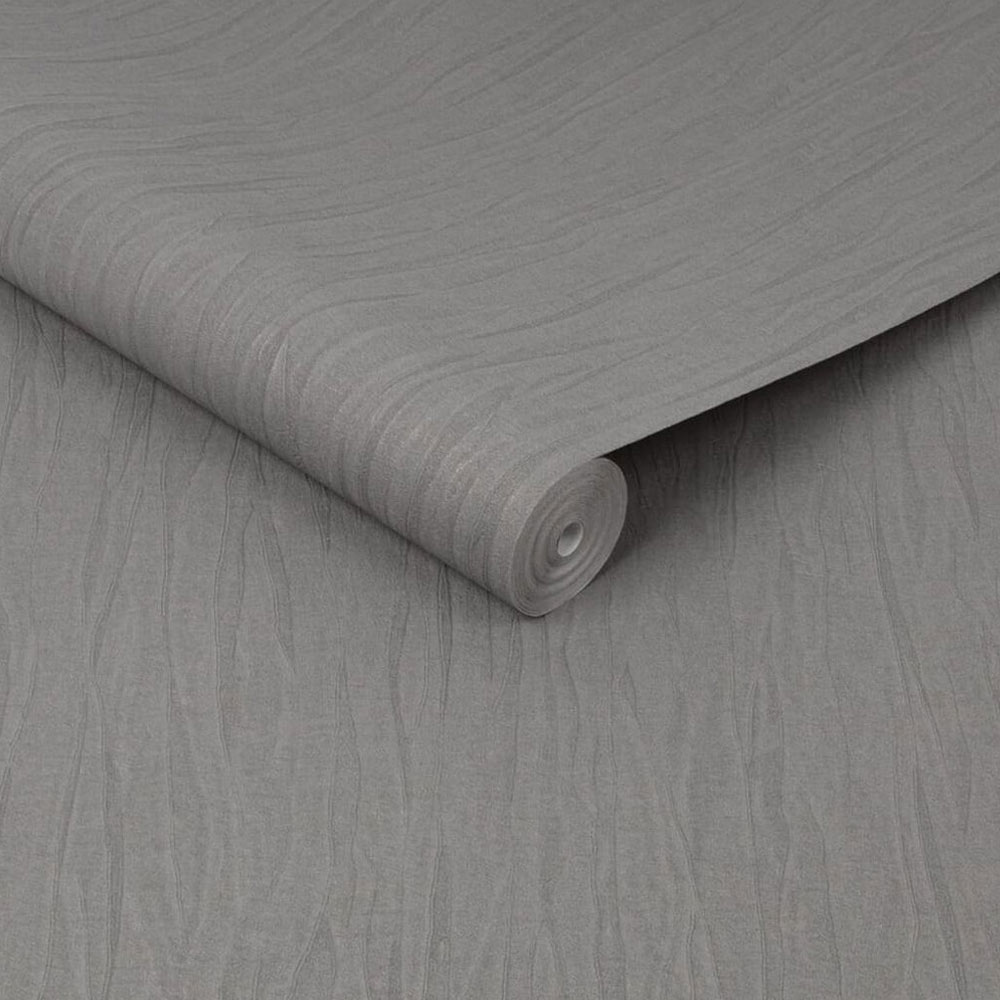 Roll of warm grey folded silk wallpaper with metallic flecks, slightly unrolled
