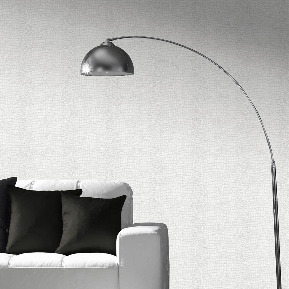 Lounge photo with installed Crocodile Wallpaper in White with a couch with pillows and standing lamp