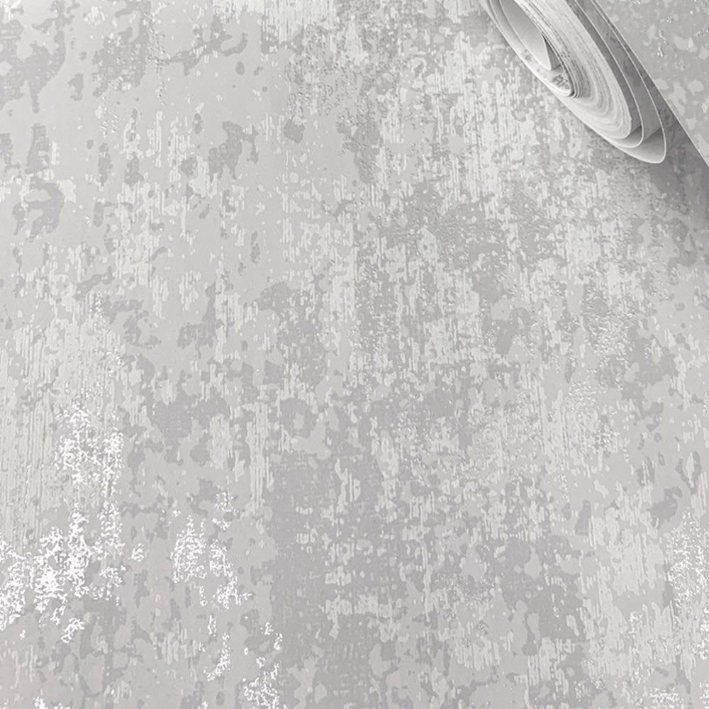 Close up of the distressed concrete wallpaper in grey and silver showing chalk-like print effect