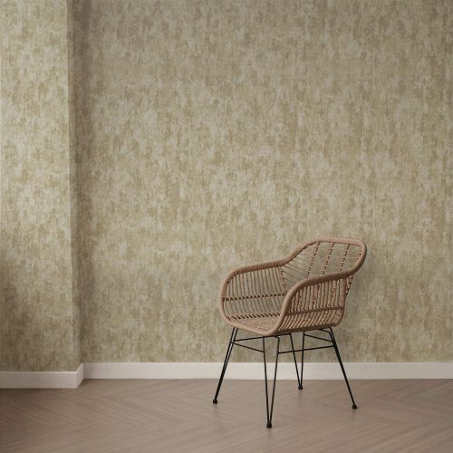 Styled photo of the weathered concrete beige gold installed on the wall and modern wooden floor. Foreground features a single rattan chair