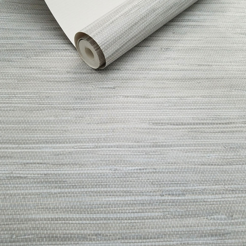 Roll of grey grasscloth wallpaper, slightly unrolled - showing realistic texture and hue