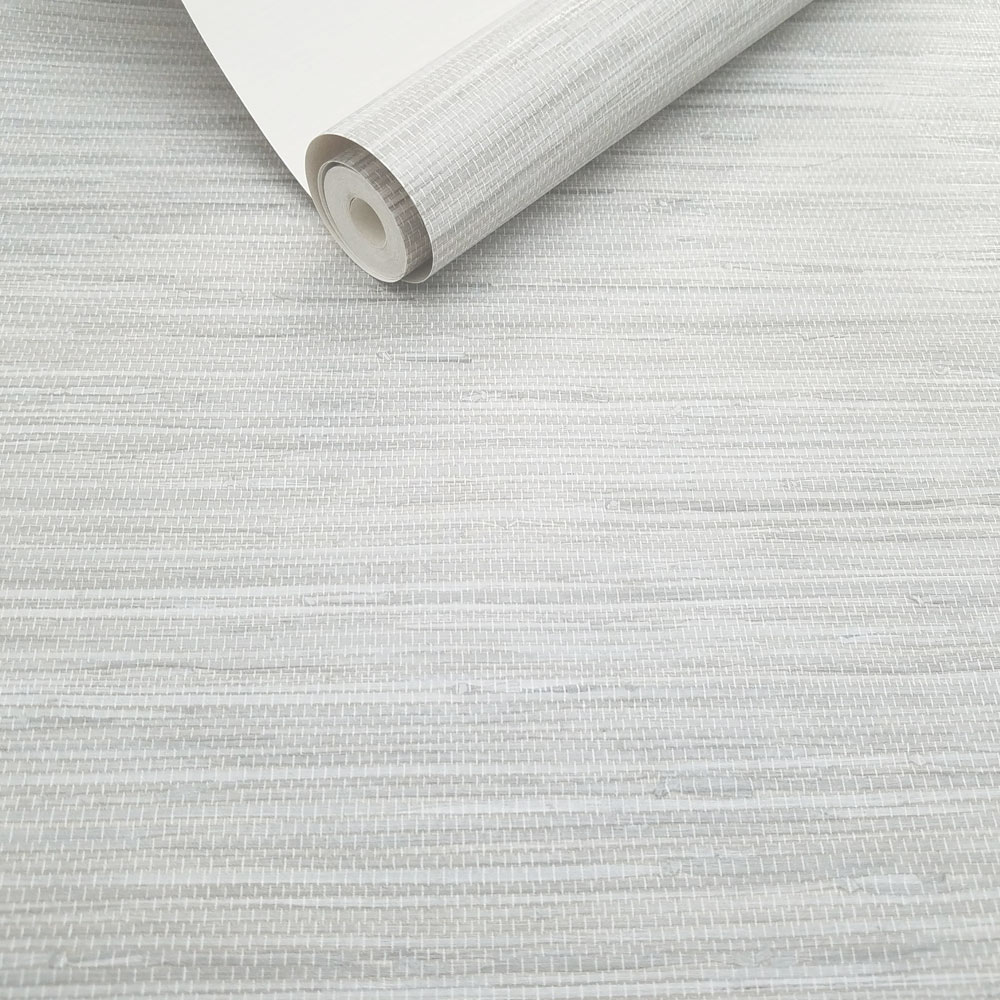 Roll of light grey faux grasscloth wallpaper, slightly unrolled