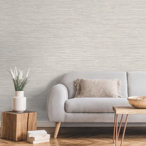 Lounge with woven grasscloth wallpaper light beige installed on the wall. Also features a couch. coffee table and side table with plant